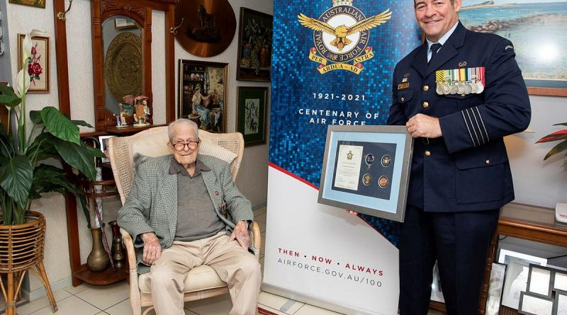 Senior ADF Officer RAAF Base Amberley Group Captain Iain Carty presents Air Force veteran Kevin Statham with an Air Force 2021 commemorative memento. Story by Evita Ryan. Photo by Leading Aircraftwoman Emma Schwenke.