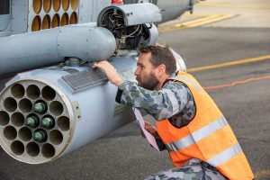 Advance Precision Kill Weapons System laser guided rocket being installed on a MH-60R.  File photo by Chief Petty Officer Cameron Martin from 2020.