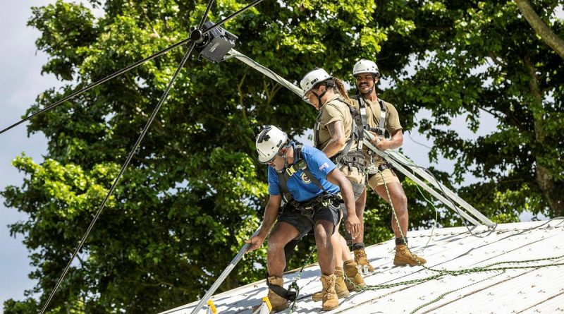 Privates Hayley Freeman and Osama Ahmed and Vanuatu Police Maritime Wing Constable Sione Motoutorua, install bracketing onto the roof of the Bwatnupni Police Post in Pentecost, Vanuatu. Story and photo by Corporal Olivia Cameron.