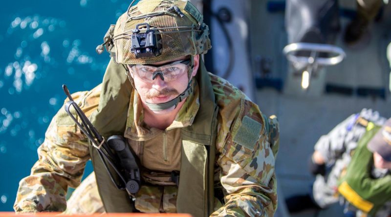 An Australian Army soldier climbs aboard HMAS Ballarat from a Rigid-Hulled Inflatable Boat during joint pre-landing force training, off the coast of Queensland, during Exercise Talisman Sabre 2021. Story by Lieutenant Commander Ryan Zerbe. Photo by LSIS Ernesto Sanchez.