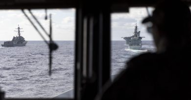 HMAS Brisbane’s Navigating Officer, Lieutenant Marita Knack, looks on as the ship sails astern of (L to R) USS Rafael Peralta, USS America and HMCS Calgary off the coast of QLD, during Exercise Talisman Sabre 2021. Story by Lieutenant Sarah Rohweder. Photo by Leading Seaman Daniel Goodman.