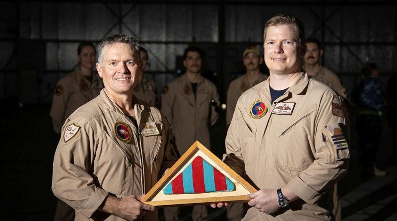 The Commander's Pennant for Air Task Group 630 is passed from outgoing commander Wing Commander Ric Peapell, left, to the incoming commander Wing Commander Alexander Cave. Photo by Glen McCarthy.