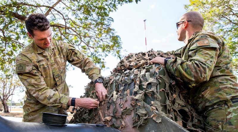 Private Samuel Bennett, left, and Private Jesse Stroud, from the 1st Battalion, Royal Australian Regiment, prepare equipment at Lavarack Barracks, Townsville, prior to deploying on Exercise Talisman Sabre 2021. Story by Flight Lieutenant Chloe Stevenson. Photo by Leading Aircraftwoman Emma Schwenke.