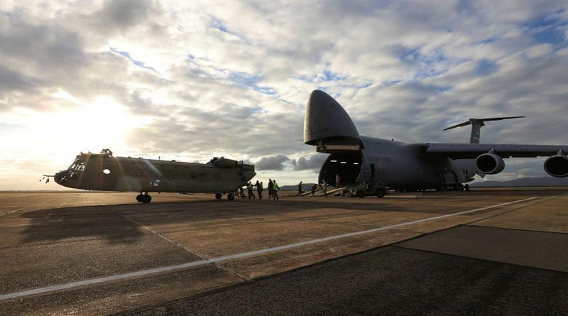 A new CH-47F Chinook heavy-lift helicopter is unloaded from a United Stated C-5 Galaxy at RAAF Base Townsville, Queensland. Photo by Trooper Lisa Sherman.