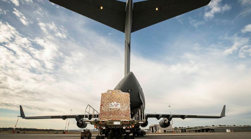 Humanitarian aid equipment is loaded into a No. 36 Squadron C-17A Globemaster III aircraft bound for Fiji. Story by Lieutenant Gordon Carr-Gregg. Photo by Sergeant Ben Dempster.