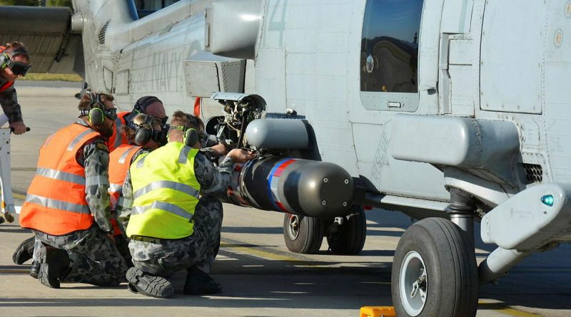 No. 816 Squadron Flight 7 maintenance team re-arms MH-60R helicopter Tiger 14 with a torpedo during the anti-submarine warfare phase of Exercise Tigerfish. Story by Lieutenant Thomas Kennedy.