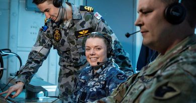 US Army’s Chief Warrant Officer 2 Robert Schenk, right, Air Force’s Flight Lieutenant Rebekah Johnson-Costigan and Navy’s Lieutenant Michael Van Den Berg in HMAS Brisbane's operations room. Story by Lieutenant Sarah Rohweder. Photo by Leading Seaman Daniel Goodman.