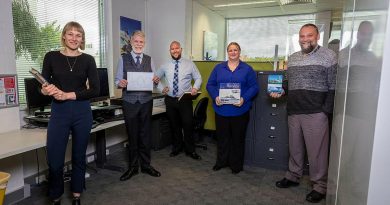 Naval History Section staff Honae Cuffe, Director John Perryman, Rob Garratt, Simone Alferink and Petar Djokovic celebrate the publication of their 400th ship history at their offices in Fyshwick, Canberra. Story and photo by Sergeant Sebastian Beurich.