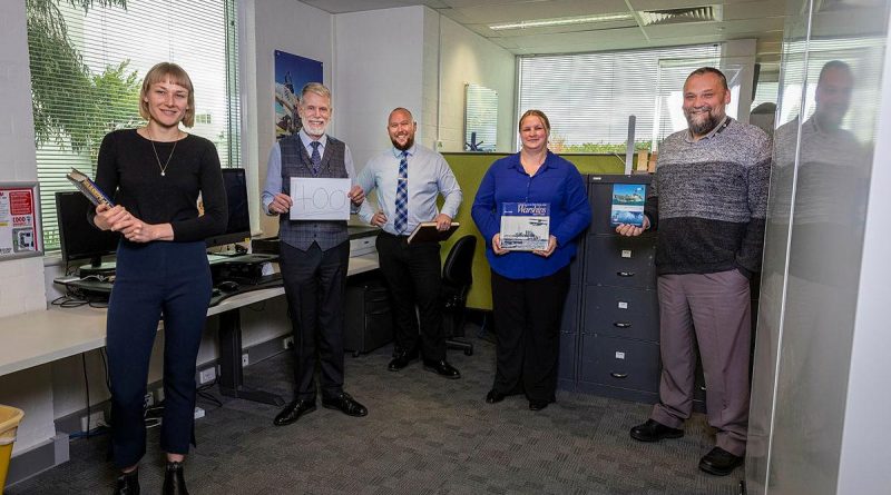 Naval History Section staff Honae Cuffe, Director John Perryman, Rob Garratt, Simone Alferink and Petar Djokovic celebrate the publication of their 400th ship history at their offices in Fyshwick, Canberra. Story and photo by Sergeant Sebastian Beurich.