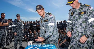 Commanding Officer Ballarat Commander Antony Pisani, right, with the youngest crew member Seaman Christiaan Rijkaart during the cutting of the ship’s birthday cake at sea. Story by Lieutenant Gary McHugh. Photo by Leading Seaman Ernesto Sanchez.