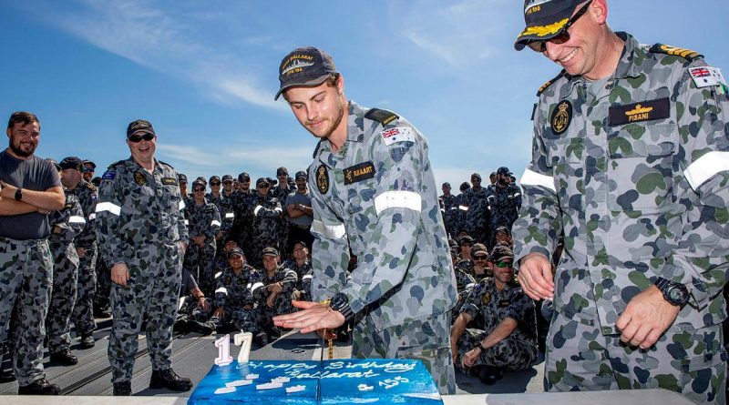 Commanding Officer Ballarat Commander Antony Pisani, right, with the youngest crew member Seaman Christiaan Rijkaart during the cutting of the ship’s birthday cake at sea. Story by Lieutenant Gary McHugh. Photo by Leading Seaman Ernesto Sanchez.