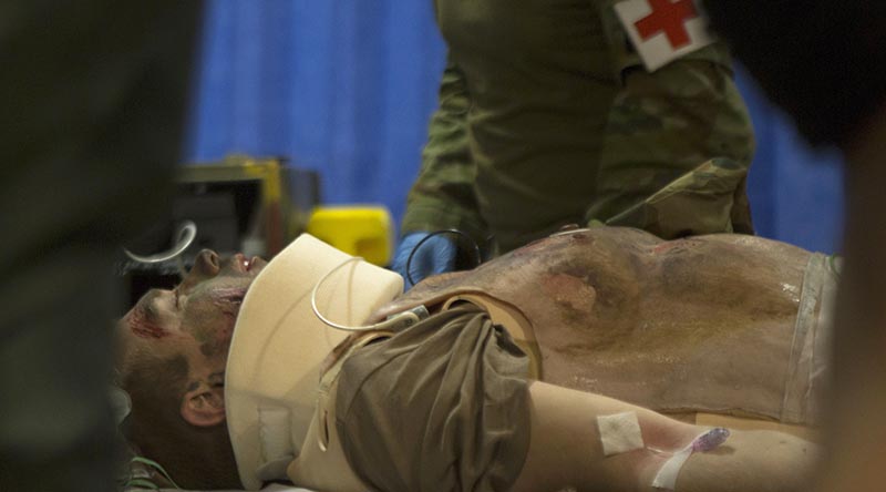 Australian Army medics with the 2nd General Health Battalion, stationed at Gallipoli Barracks in Enoggera, Queensland, simulate injury assessment and resuscitation procedures on a mass casualty exercise during Exercise Talisman Sabre 2019 at Williamson Airfield, Shoalwater. Photo by US Marine Corps Lance Corporal Kealii De Los Santos.