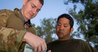 Army linguist Lance Corporal Cameron Murdoch talks with Japan Ground Self-Defense Force soldier Sergeant First Class Shigeyuki Azuma during Exercise Southern Jackaroo. Story and photo by Private Jacob Joseph.