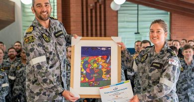 Commanding Officer NUSHIP Stalwart Commander Steve McCraken presents Leading Seaman Medic Abbey-Rose Yeomans with her award and artwork at HMAS Stirling in Rockingham. Story by Dallas McMaugh. Photo by Able Seaman Luke Miller.