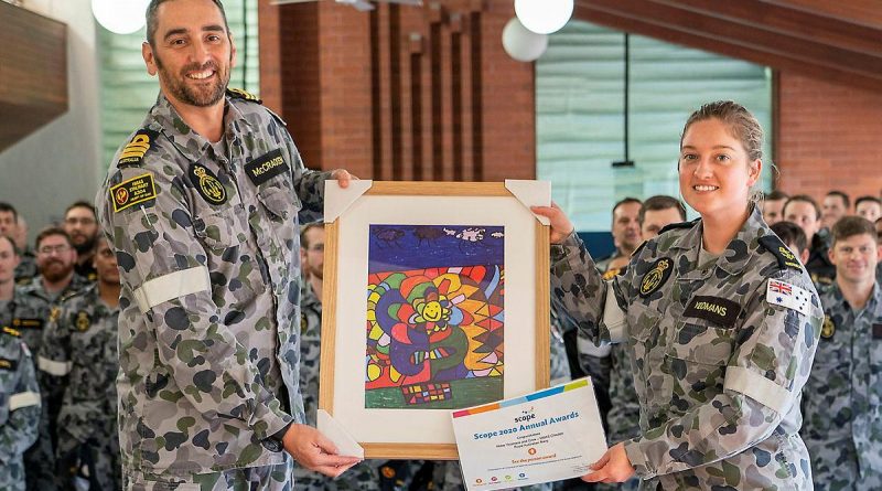 Commanding Officer NUSHIP Stalwart Commander Steve McCraken presents Leading Seaman Medic Abbey-Rose Yeomans with her award and artwork at HMAS Stirling in Rockingham. Story by Dallas McMaugh. Photo by Able Seaman Luke Miller.