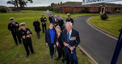 Commodore Jim Dickson (retd) unveils the sign for the new road named in his honour at HMAS Cerberus, joined by members of his family and senior Cerberus personnel. Story by Lieutenant Commander Helen Ward. Photo by Petty Officer James Whittle.