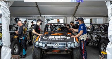 Corporal David Seymour, of the 2nd Cavalry Regiment, speaks with Super Truck driver Toby Price during the NTI Townsville 500 Supercars event. Story by Captain Diana Jennings. Photo by Corporal Brodie Cross.