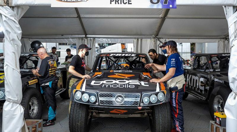 Corporal David Seymour, of the 2nd Cavalry Regiment, speaks with Super Truck driver Toby Price during the NTI Townsville 500 Supercars event. Story by Captain Diana Jennings. Photo by Corporal Brodie Cross.