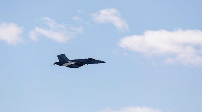 A Royal Australian Air Force FA-18A Classic Hornet aircraft approaches HMAS Brisbane during an air-warfare serial, off the coast of Queensland during Exercise Talisman Sabre 2021. Story by Lieutenant Sarah Rohweder. Photo by Leading Seaman Daniel Goodman.