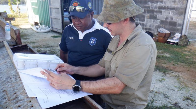 SIG Wayne Tranter provides a site brief to Papua New Guinea Navy Able Seaman Basil as part of the Communications Infrastructure Upgrade on Manus Island. Story by Leading Seaman Kylie Jagiello.