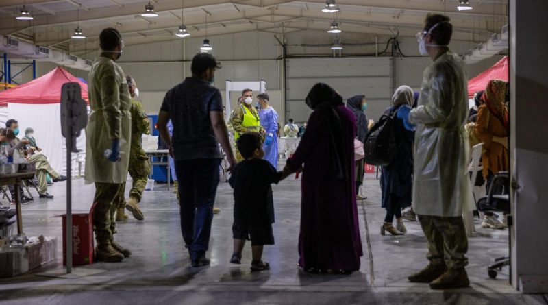 Evacuees enter the evacuee handling centre at Australia’s main operating base in the Middle East, following their evacuation from Kabul, Afghanistan. (This image has been digitally manipulated). Story by Lieutenant Max Logan. Photo by Leading Aircraftwoman Jacqueline Forrester.