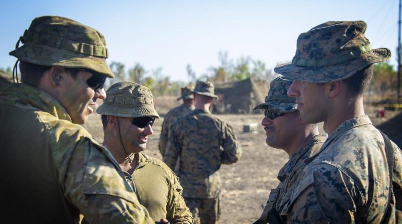 Australian soldiers from 1st Combat Signal Regiment discuss upcoming training with marines at Bradshaw Field Training Area during Exercise Koolendong. Story and photo by Captain Carla Armenti.