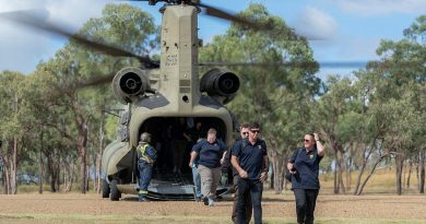 Australian Institute of Sport representatives exit a CH-47 Chinook at the Townsville Field Training Area during a visit to the Command Training Centre in Townsville, Queensland. Story by Paulina Acuna. Photo by Corporal Sagi Biderm.