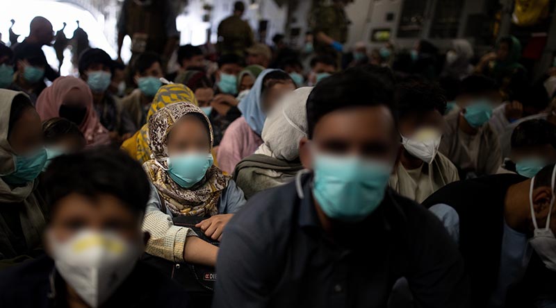 Afghan families are packed into a Royal Australian Air Force C-17A Globemaster III for evacuation from Hamid Karzai International Airport in Kabul, Afghanistan. Photo by Sergeant Glen McCarthy.