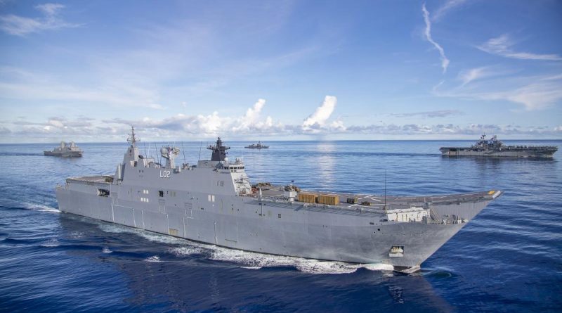 HMAS Canberra, front, conducts manoeuvres with USS New Orleans, left, JS Makinami and USS America during the Large Scale Global Exercise in the Western Pacific. Photo by Leading Seaman Ernesto Sanchez.