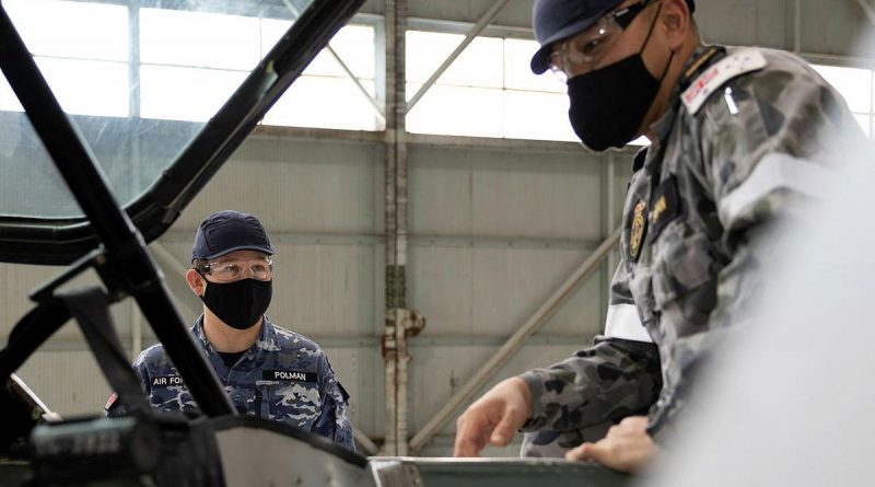 Trainee avionics technician Seaman Nattapol Popan, right, receives theory instruction from Royal Australian School of Technical Training Instructor Flight Lieutenant Chris Polman. Story by Flight Lieutenant Julia Ravell.