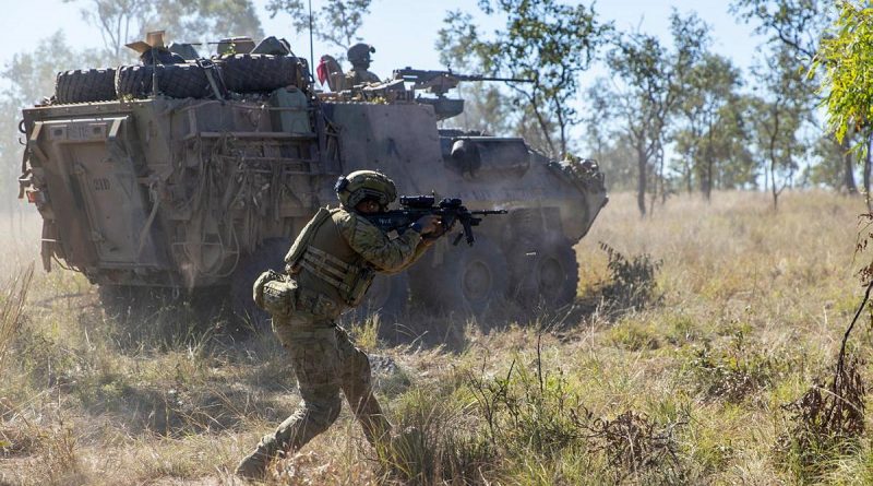 Private Harry Price from the 1st Battalion, Royal Australian Regiment, and mounted soldiers from the 2nd Cavalry Regiment engage an enemy position during Exercise Eagle Run at the Townsville Field Training Area. Story by Captain Lily Charles. Photo by Corporal Brodie Cross.