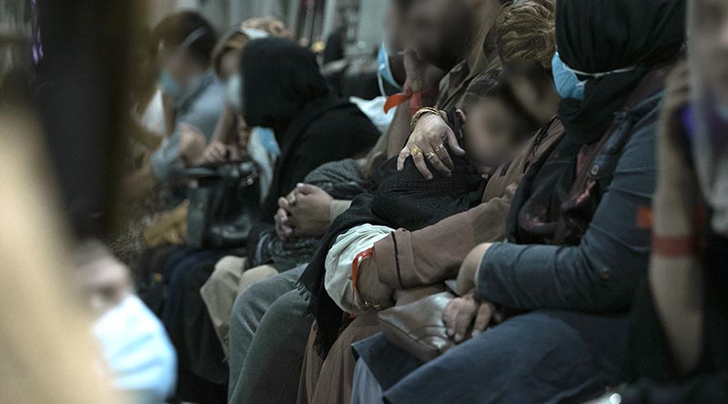 Families departing Afghanistan aboard a RAAF C-17A Globemaster prepare for departure from Hamid Karzai International Airport. Photo by Leading Aircraftwoman Jacqueline Forrester.