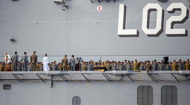 The ship's company of HMAS Canberra commemorates the 79th anniversary of the Battle of Savo Island on the flight deck while at sea in the Western Pacific. Story by Lieutenant Sarah Rohweder. Photo by Leading Seaman Ernesto Sanchez.