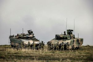 Soldiers from the 7th Battalion, Royal Australian Regiment, stand with the Hanwha Defense Australia Redback, left, and Rheinmetall Defence Australia Lynx KF-41, right, infantry fighting vehicles. Photo by Sergeant Jake Sims.