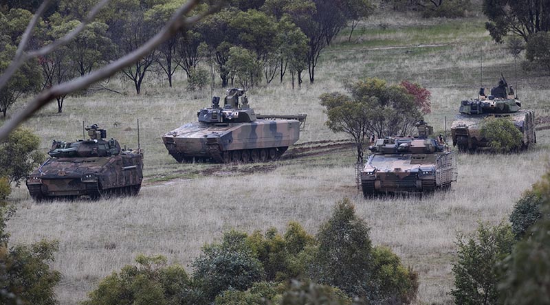 Hanwha Defense Australia Redback Infantry Fighting Vehicle (front) and Rheinmetall Defence Australia LYNX KF41 Infantry Fighting Vehicle (back), conduct LAND 400 Phase 3 user evaluation trials at Puckapunyal Military Area, Victoria. Photo by Corporal Sagi Biderman. 