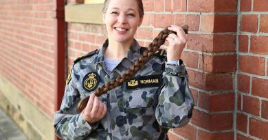 Leading Seaman Musician Miriam Norman from the Royal Australian Navy Band Tasmania shows of the braid of hair she has donated to charity.