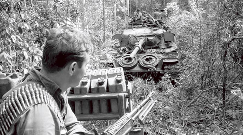 Private Frank Jelen of 3RAR sitting on an armoured recovery vehicle during Operation Overlord on the border of Phuoc Tuy and Long Khanh Provinces, June 1971.