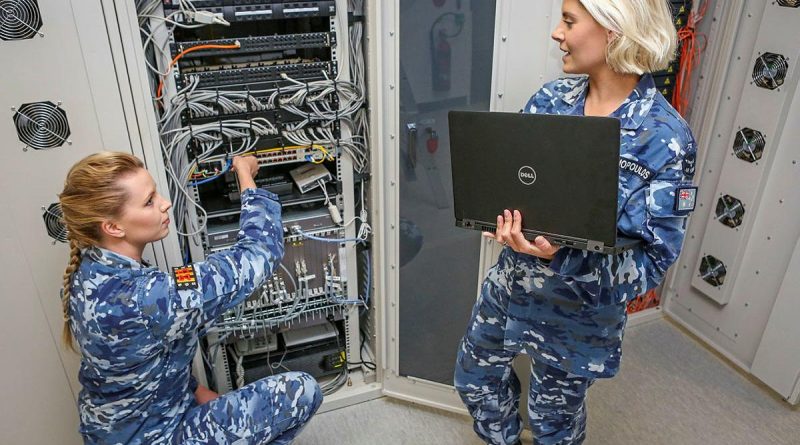 Aircraftwoman Lauren Campbell, left, with Corporal Natalie Ekonomopoulos in a communications cabinet for cyber research and development systems at No. 462 Squadron. Story by Flight Lieutenant Georgina MacDonald. Photo by Corporal Brenton Kwaterski.