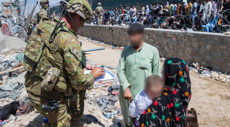 Major Tim Glover assists DFAT members locate Afghan Australian visa holders attempting to enter the congested Abbey Gate at Hamid Karzai International Airport. Story by Lieutenant Max Logan. Photo by Sergeant Glen McCarthy.