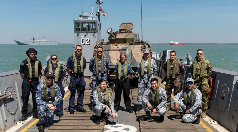 Embarked foreign personnel for Indo-Pacific Endeavour 21 stand on-board a Light Landing Craft from HMAS Canberra off the Port of Darwin before departing for Exercise Indo-Pacific Endeavour 21. Story by Captain Peter March. Photo by Leading Seaman Sittichai Sakonpoonpol.