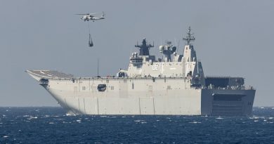 HMAS Anzac's embarked MH-60R collects a desalination plant from HMAS Canberra for delivery to the Balinese island of Nusa Lembongan during IPE21. Photo by Leading Seaman Leo Baumgartner.