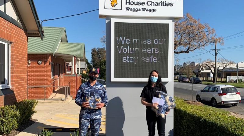 Aircraftman Antonio Keedle-Gradenza presents the donations to Lisa Simpson in Wagga Wagga. Story by Flying Officer Brent Moloney.