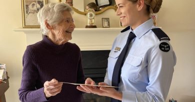 Shirley Stone shows Aircraftwoman Cassandra Field her World War II training certificate during the presentation in Adelaide. Story by Squadron Leader Bruce Chalmers.