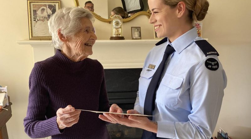 Shirley Stone shows Aircraftwoman Cassandra Field her World War II training certificate during the presentation in Adelaide. Story by Squadron Leader Bruce Chalmers.