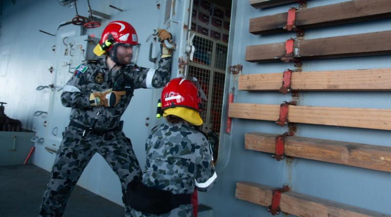 Able Seaman Paul Murra and Able Seaman Lydia Monk participate in a fire hose drill during damage control training on board HMAS Sirius. Story by Lieutenant Commander Ric Mingramm.