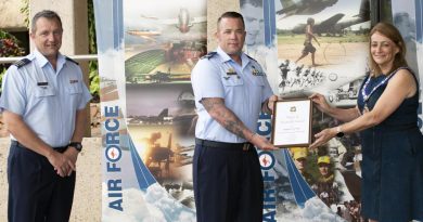 Senior ADF officer at RAAF Base Townsville Wing Commander Mathew Green watches on as Sergeant Tory Tipler is presented with his award by Townsville Mayor Jenny Hill. Story by Flying Officer Robert Hodgson.