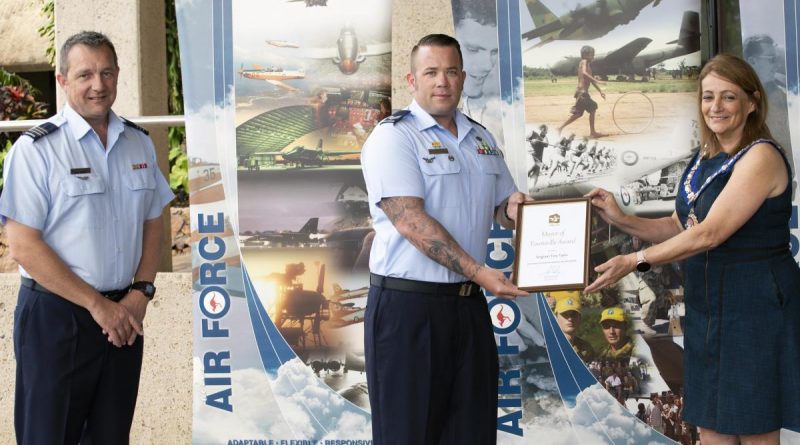 Senior ADF officer at RAAF Base Townsville Wing Commander Mathew Green watches on as Sergeant Tory Tipler is presented with his award by Townsville Mayor Jenny Hill. Story by Flying Officer Robert Hodgson.