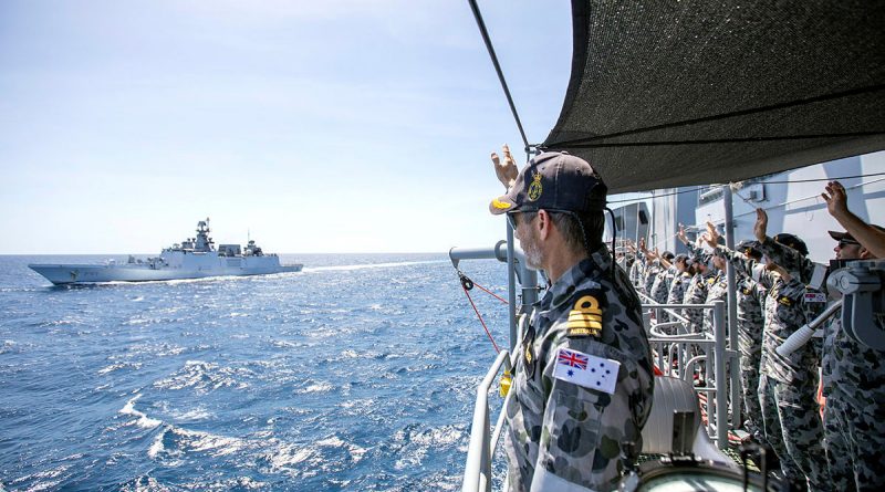 HMAS Warramunga's Commanding Officer, Commander Stewart Muller, and the Ship's Company wave farewell, as Indian Navy Ships Shivalik and Kadmaat sail past at the conclusion of AUSINDEX 2021. Story by Lieutenant Geoff Long. Photo by Petty Officer Yuri Ramsey.