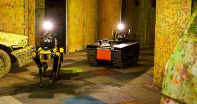 One of Team CSIRO DATA61 quadruped robots with a tracked all-terrain robot in a simulated underground-emergency environment. Photo supplied.