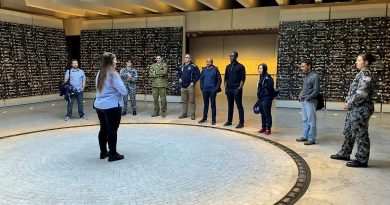 Ashleigh Taylor, from the Anzac Memorial, guides ADF Cyber Gap Program participants around the memorial in Sydney's Hyde Park.
